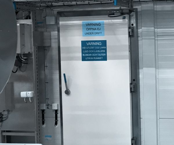 To hvide hængslede døre, der også fungerer som branddøre